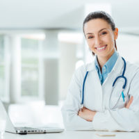 Confident female doctor at office desk